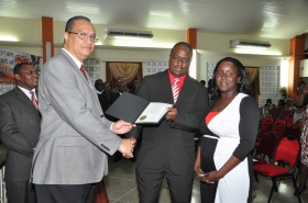Regional Director Dr Carlos Saenz presents Pastor Kevin Johnson with his Ordination Credentials at the COTN Trinidad & Tobago District Ordination Service 2014