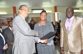 Regional Director Dr Carlos Saenz presents Pastor Christine Thompson with her Ordination Credentials at the COTN Trinidad & Tobago District Ordination Service 2014