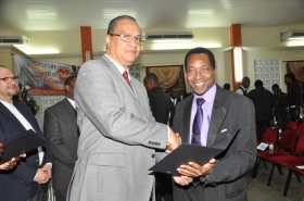 Regional Director Dr Carlos Saenz presents Pastor Peter Stroude with his Ordination Credentials at the COTN Trinidad & Tobago District Ordination Service 2014