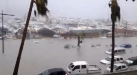 General view of half-submerged vehicles, boats and debris in the flooded harbour as Hurricane Irma hits the French island territory of Saint Martin