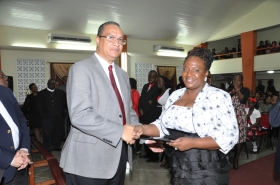 Regional Director Dr Carlos Saenz presents Pastor Alvilene Williams with her Ordination Credentials at the COTN Trinidad & Tobago District Ordination Service 2014