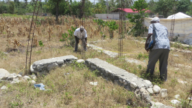 Pastor Civil and Boss Mason measure land