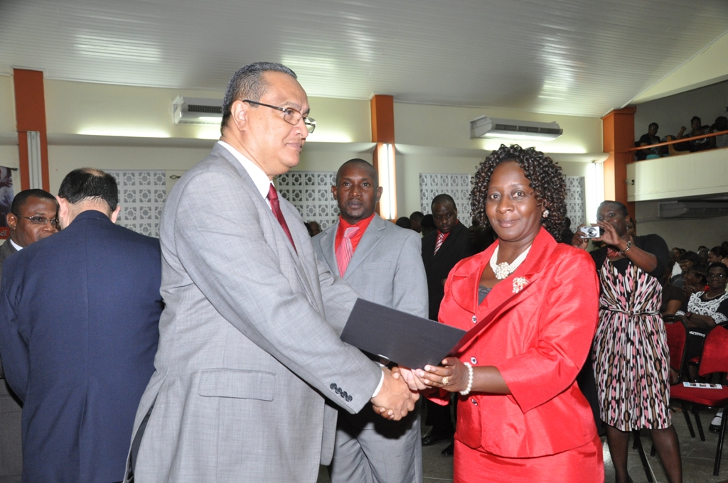 Regional Director Dr Carlos Saenz presents Pastor Hazel Ann George with her Ordination Credentials at the COTN Trinidad & Tobago District Ordination Service 2014