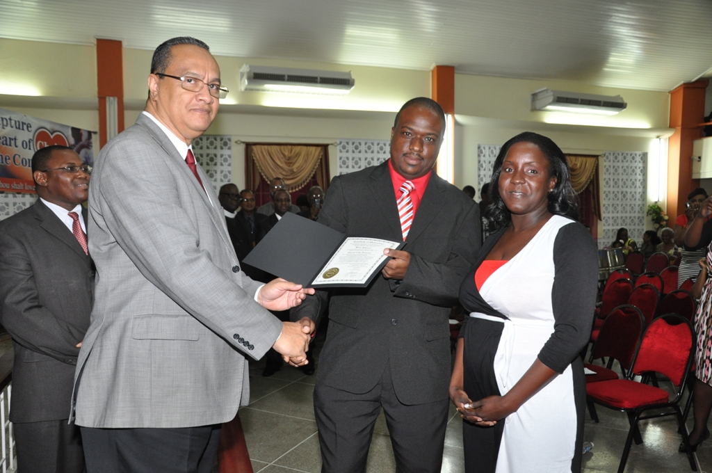 Regional Director Dr Carlos Saenz presents Pastor Kevin Johnson with his Ordination Credentials at the COTN Trinidad & Tobago District Ordination Service 2014
